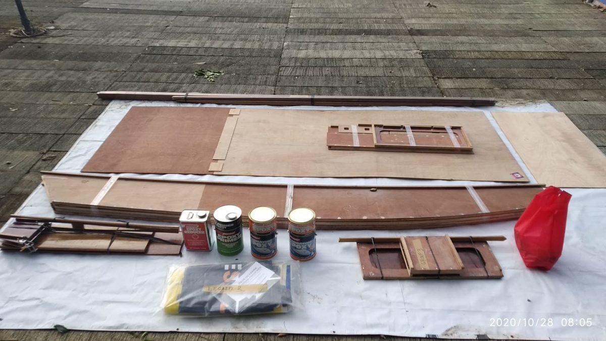 Oz Goose sailboat framing and precut plywood kit laid out on ground